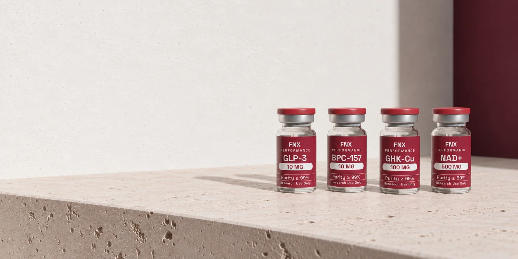 GLP-3, BPC-157, GHK-Cu and NAD+ vials on a cream limestone slab